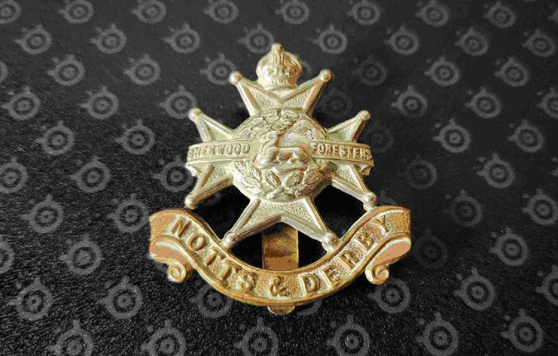 Front view of Sherwood Foresters cap badge showing stag and oak wreath on Maltese cross