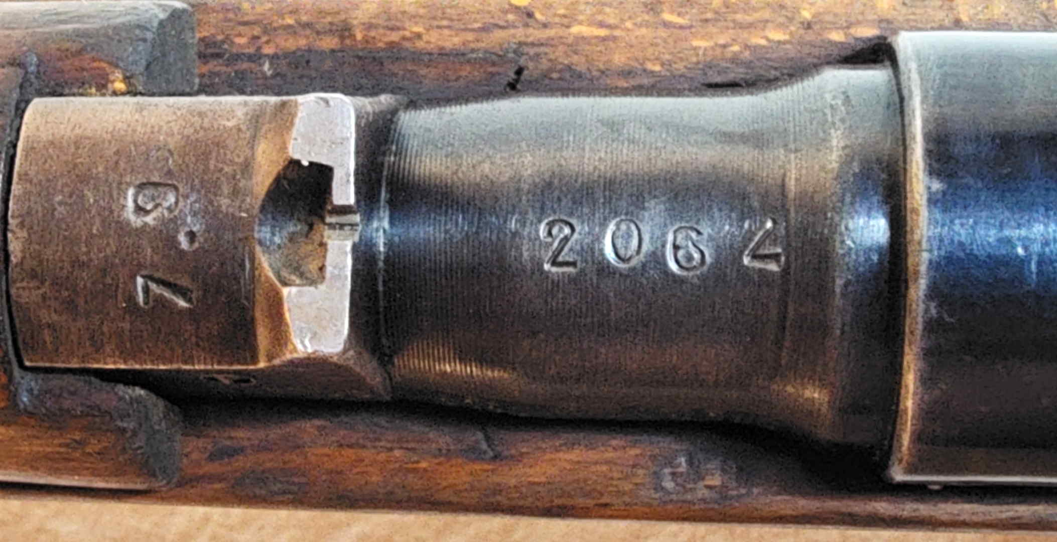 Stamped receiver serial number 2062 with adjacent small inspection marks