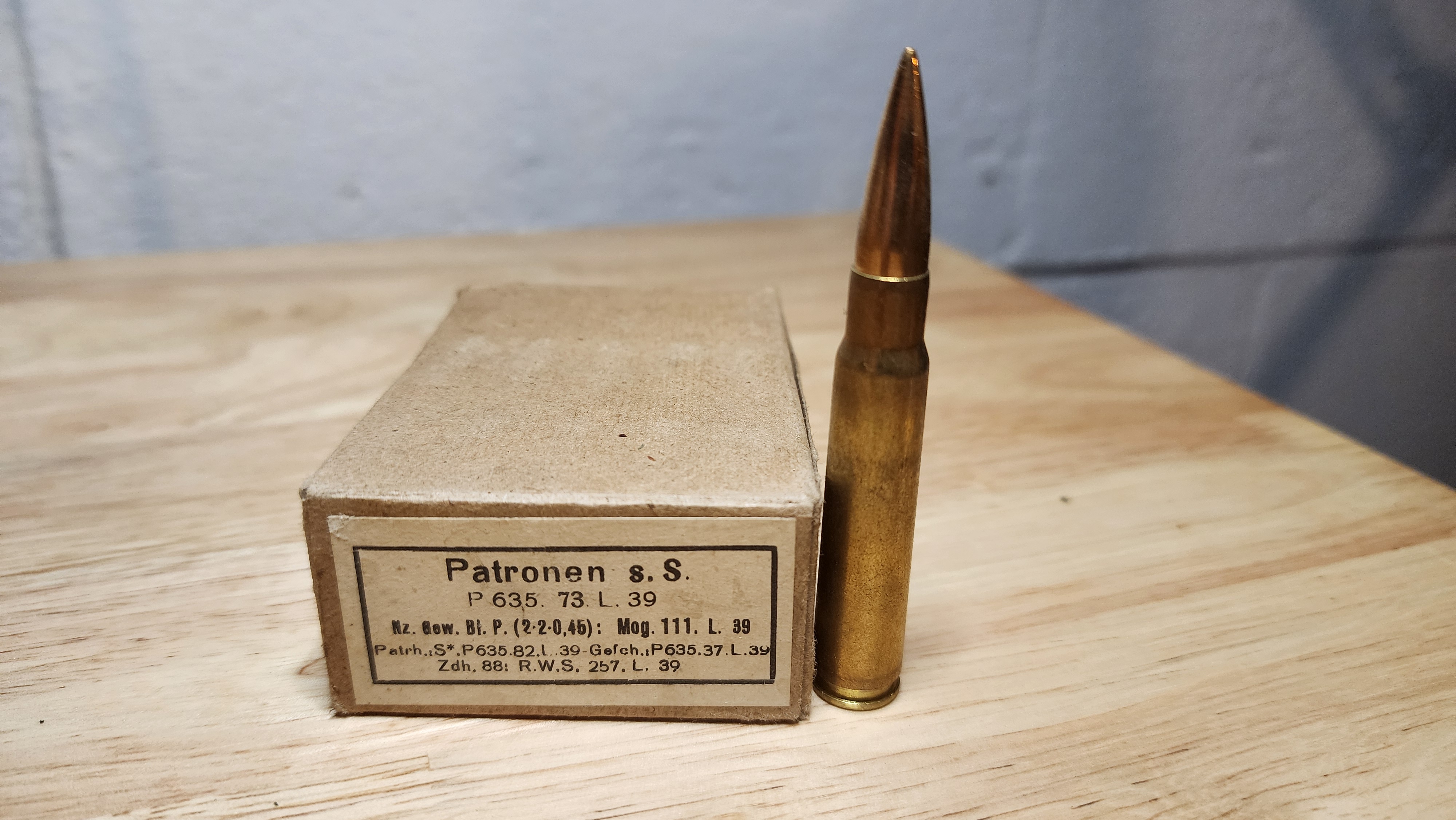 1939 German 7.92×57mm Mauser ammunition box label 'Patronen s.S.' with one cartridge displayed