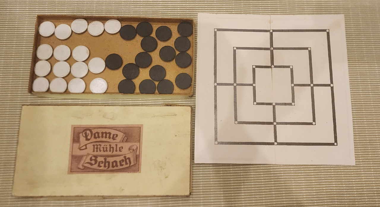 Multi-game set: black and white counters and a printed Nine Men's Morris board sheet