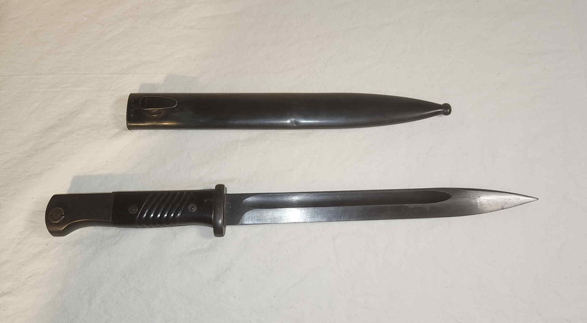 1943 German S84/98 III bayonet displayed beside its steel scabbard