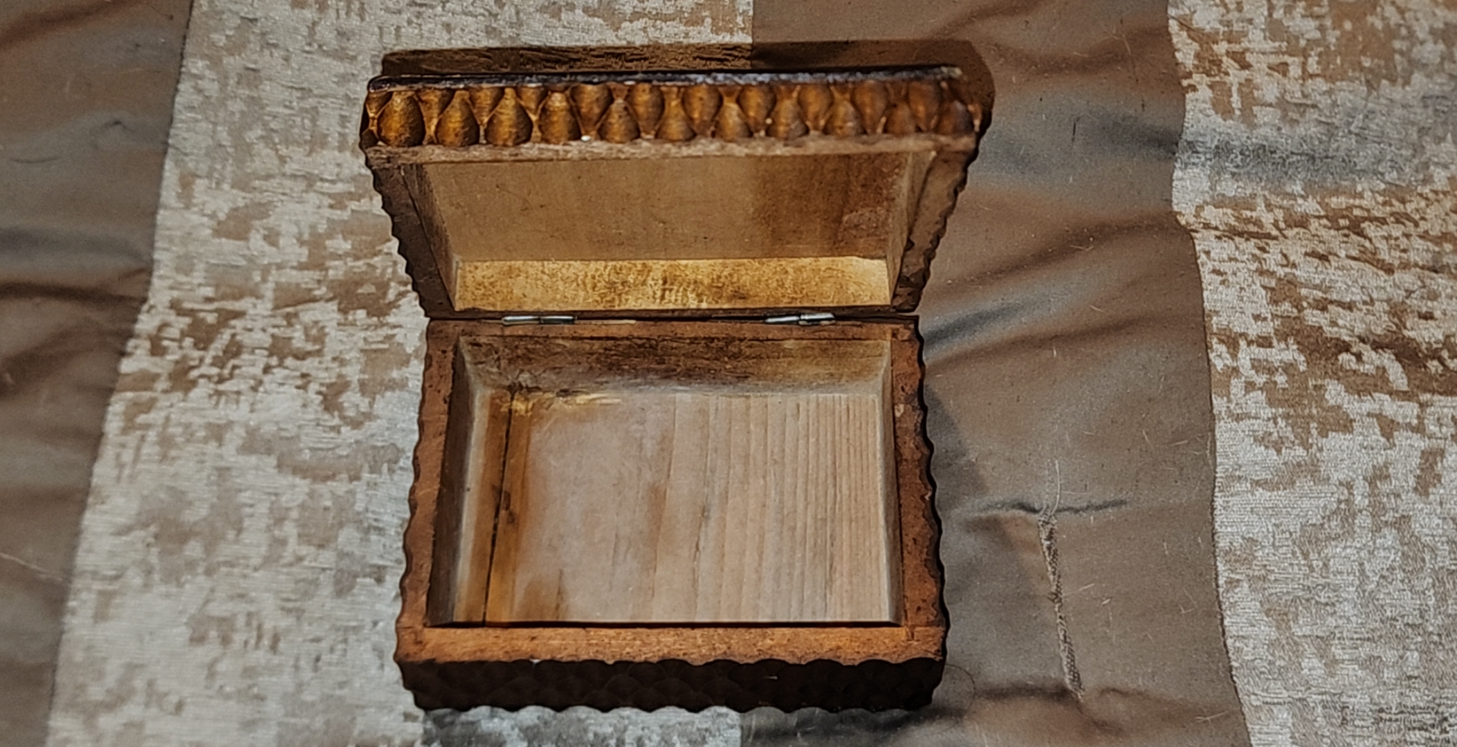 The trinket box opened showing its interior and simple hinged construction