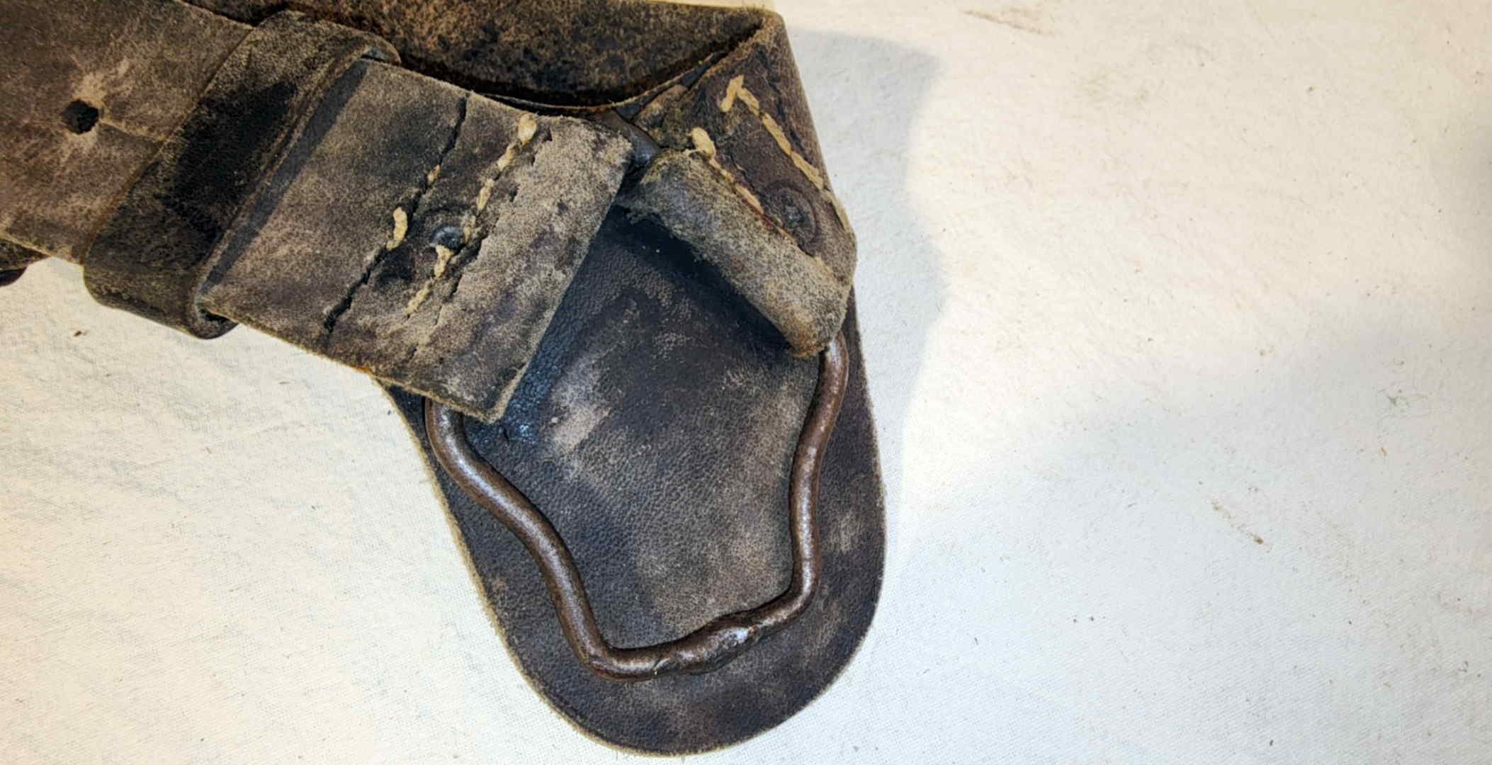 Close view of the lower holster ring and worn leather on an Italian M91 cavalry bandolier