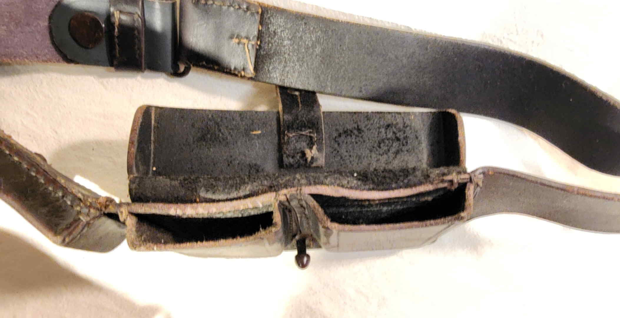 Open ammunition compartments of an Italian Modello 1897 M91 Carcano cavalry bandolier