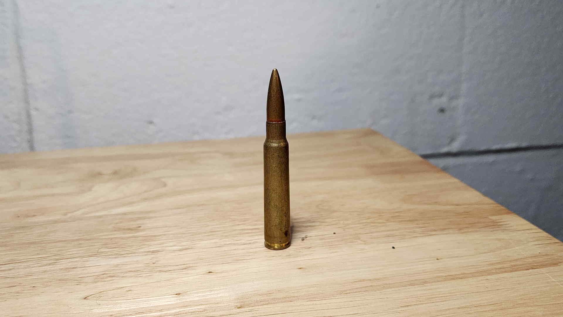 Standing side view of a 7.7×58mm Type 99 Arisaka cartridge