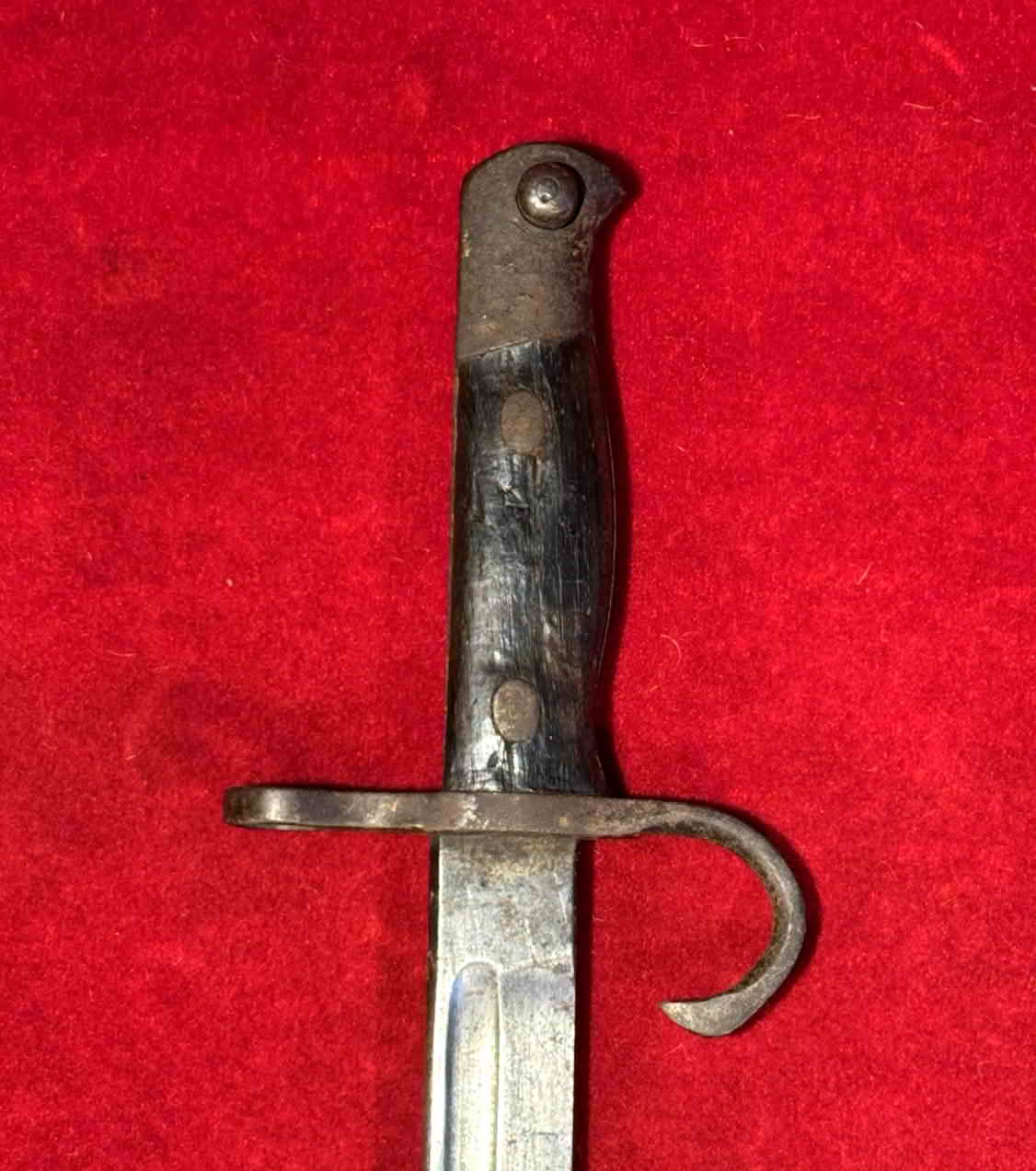 Hilt of the Type 30 bayonet showing the contoured wood grip and working press stud