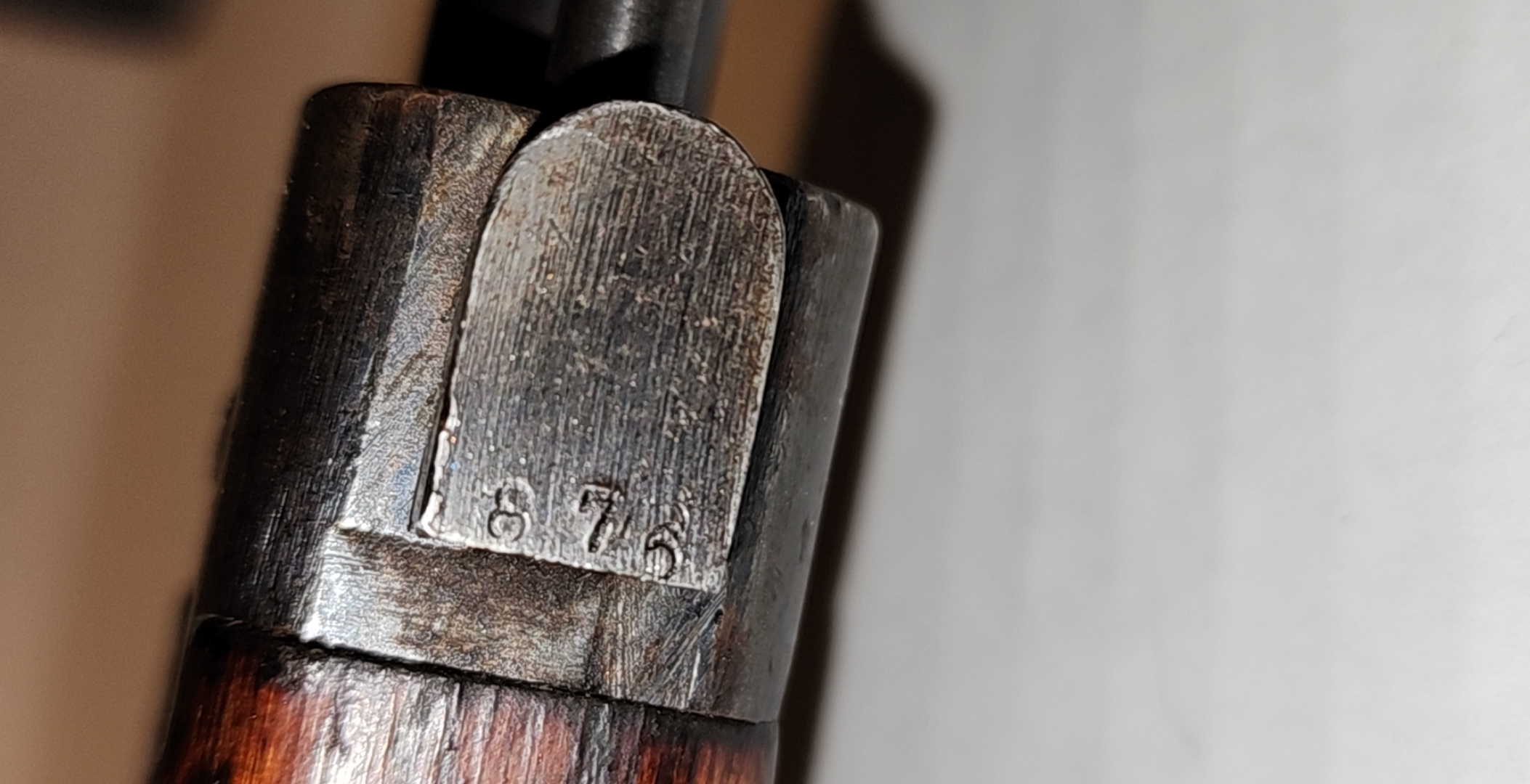 Bayonet lug serial marking on an Arisaka Type 99, showing 876