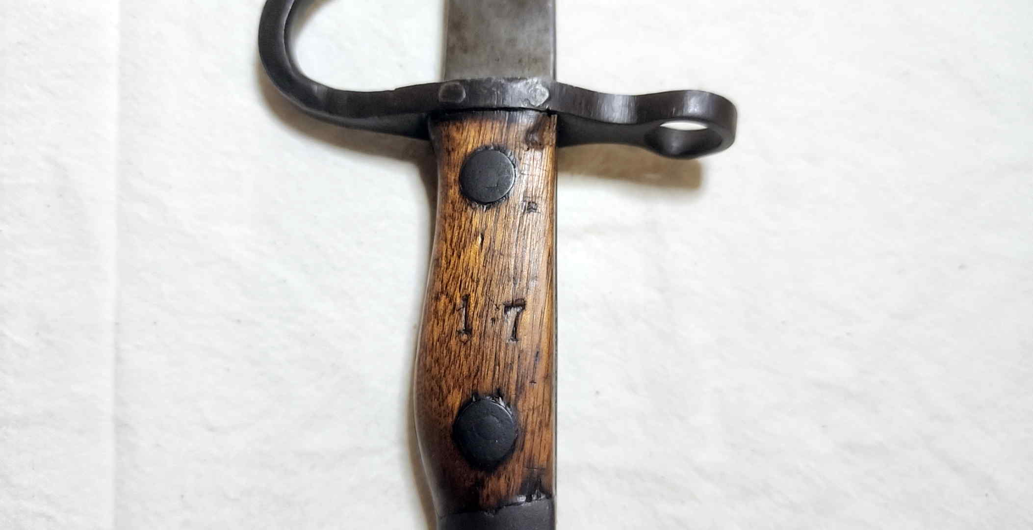 Wood grip of the Japanese school bayonet stamped with the inventory number 17