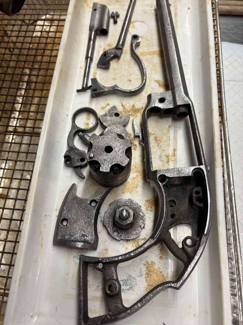Parts tray showing components of the revolver during restoration