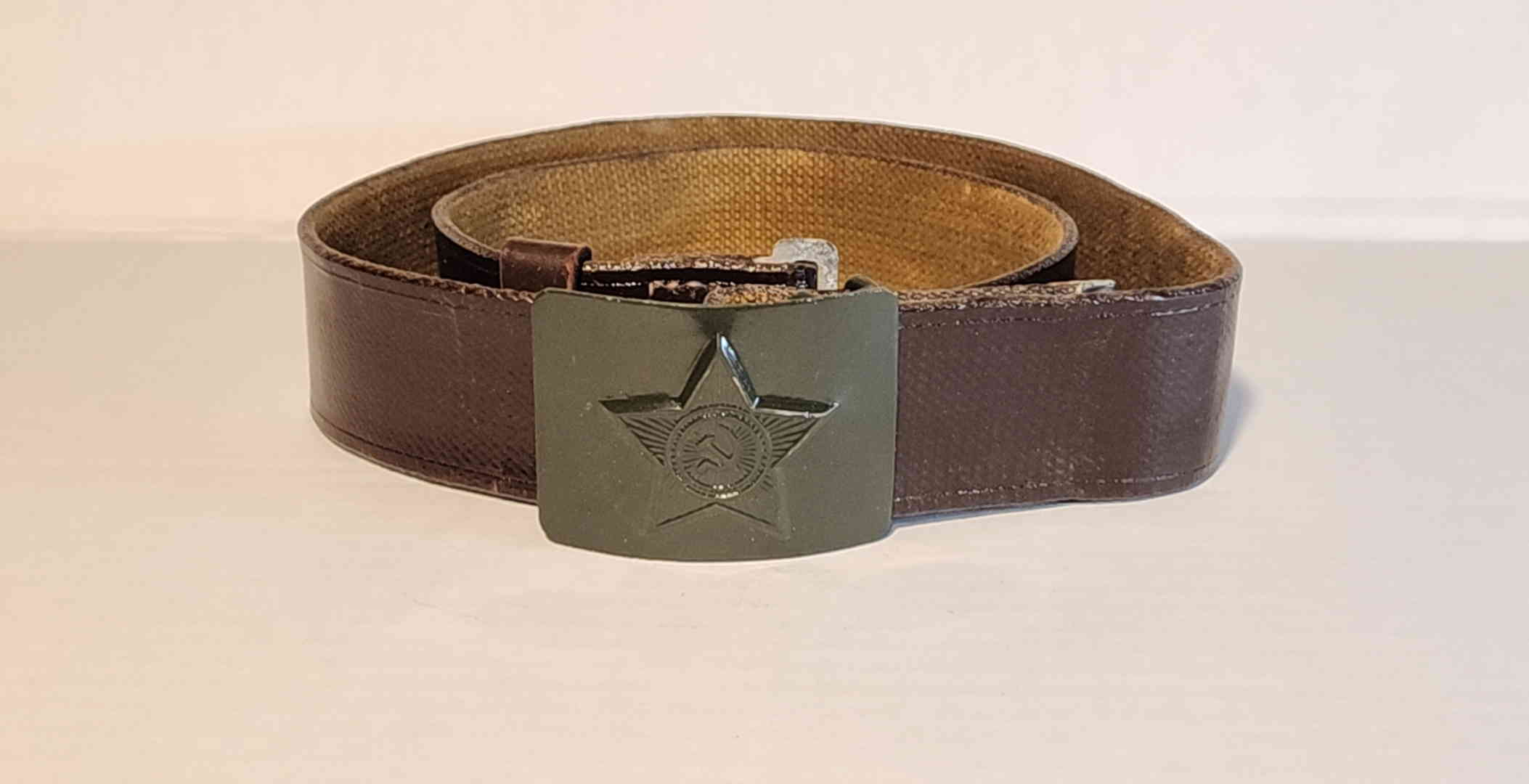 Soviet M69 field belt front view showing olive-green painted buckle with star and hammer-and-sickle motif
