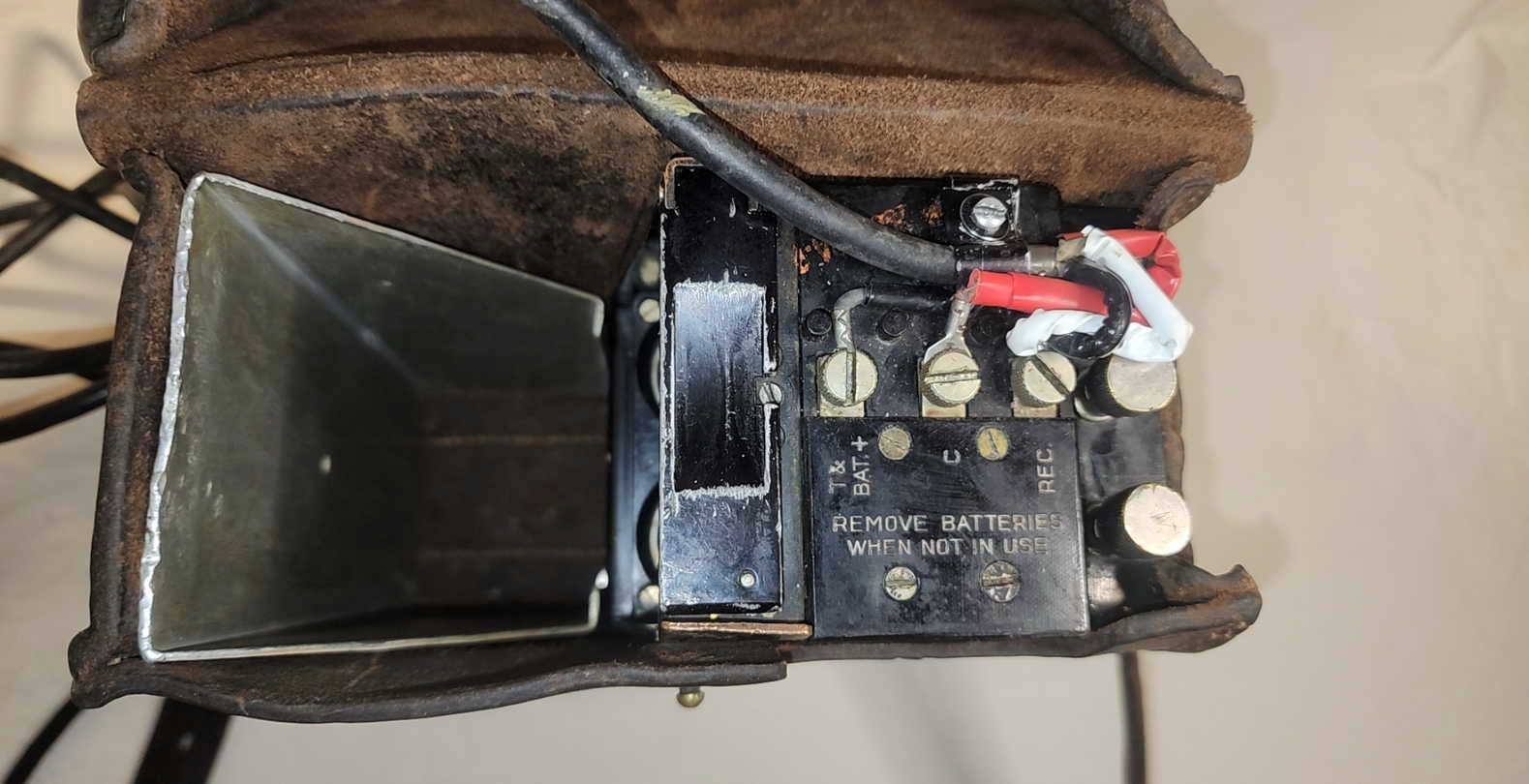 Top view of the EE-8-A interior with case open, showing connectors, signal plate, and handset stowage channel