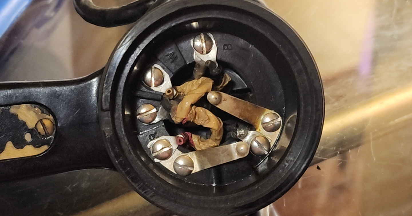 TS-9 handset mouthpiece interior during troubleshooting with wiring and terminals exposed