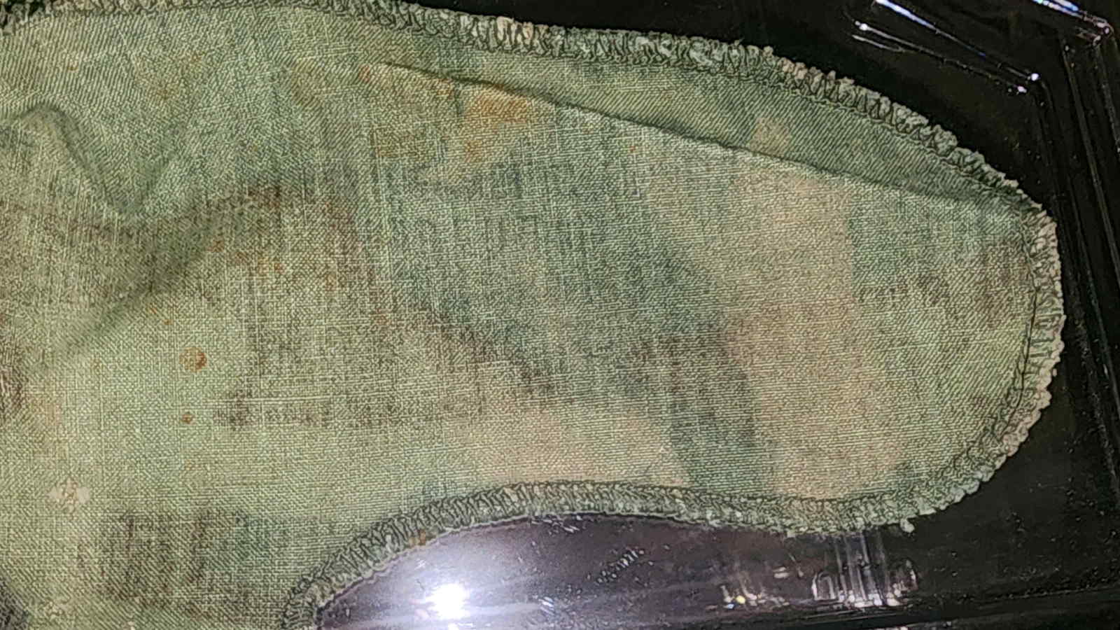 Close-up of ERDL helmet cover markings with faded text