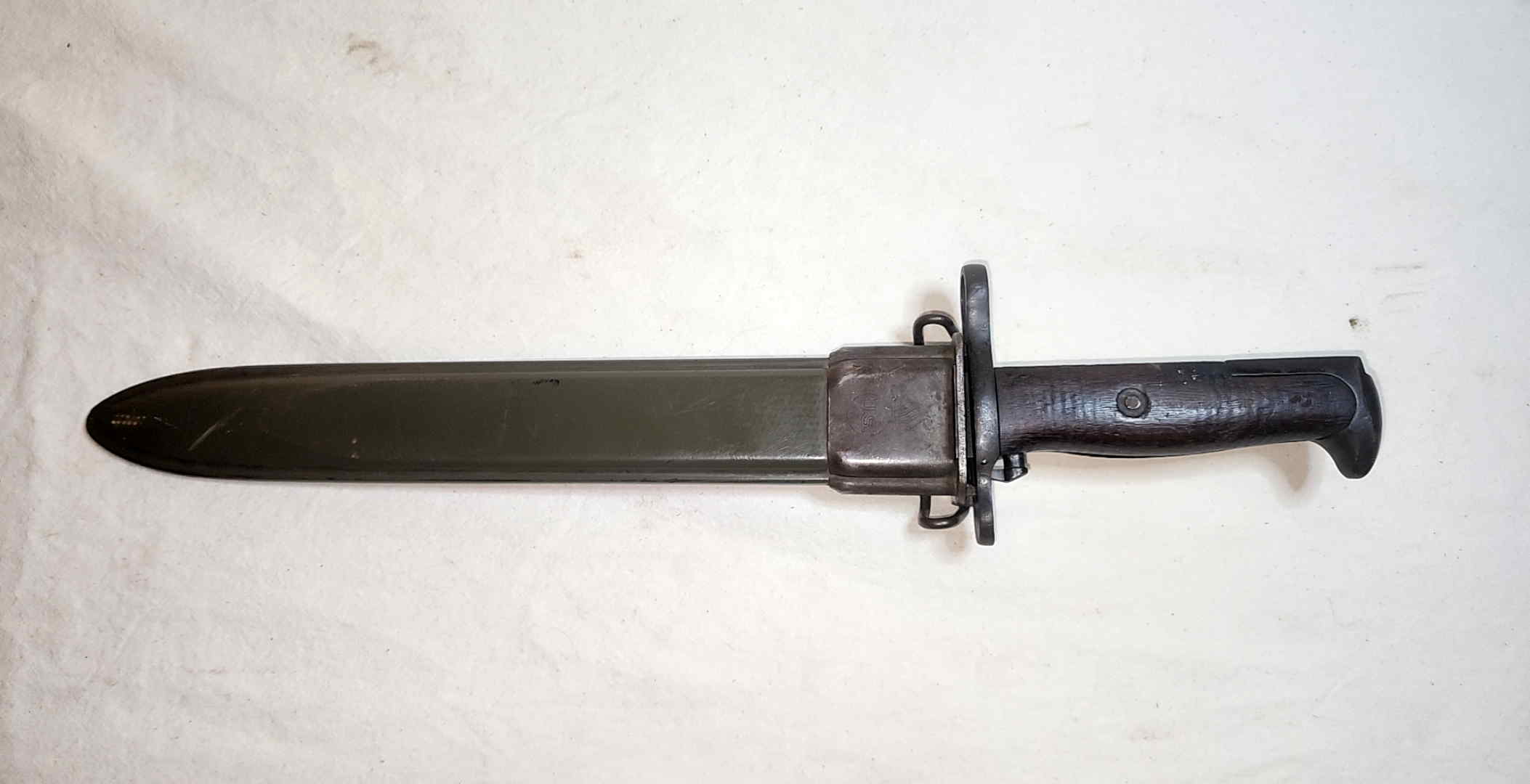 Springfield Armory Model 1905 bayonet seated in its olive-drab M7-length fiberglass scabbard
