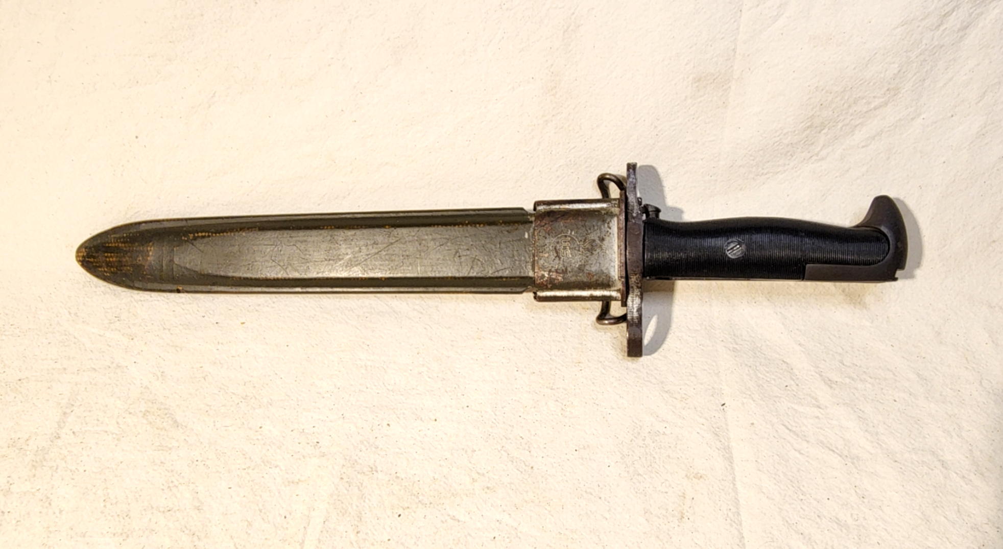 Union Fork and Hoe M1 bayonet seated in a short green scabbard