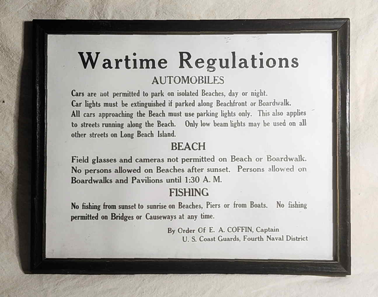 Framed World War II Long Beach Island wartime regulations notice issued under Captain E. A. Coffin of the U.S. Coast Guard Fourth Naval District